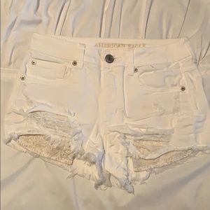 High waisted white distressed denim shorts.